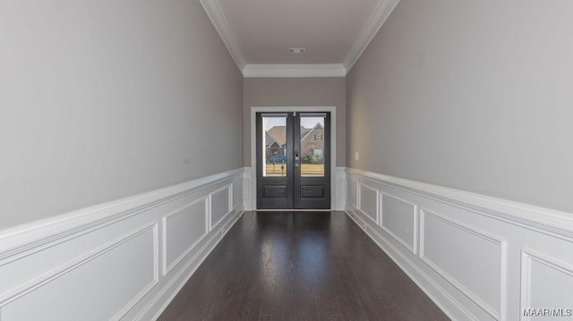 doorway to outside featuring french doors, dark wood-type flooring, and ornamental molding