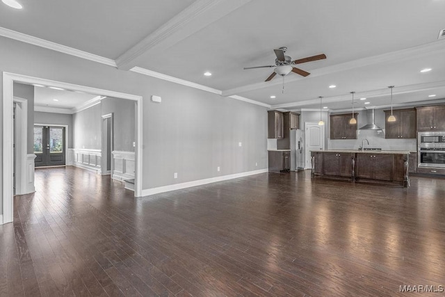 unfurnished living room featuring ceiling fan, sink, french doors, dark hardwood / wood-style flooring, and ornamental molding