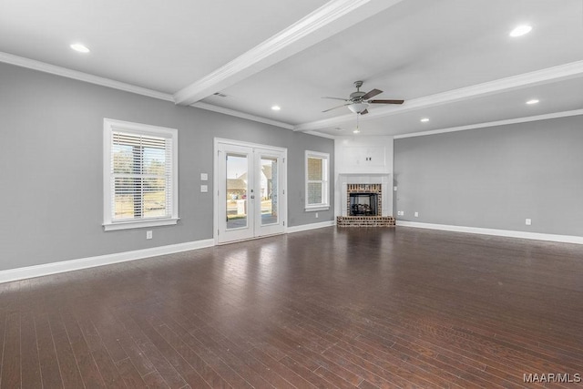 unfurnished living room with ceiling fan, beam ceiling, ornamental molding, and dark hardwood / wood-style floors