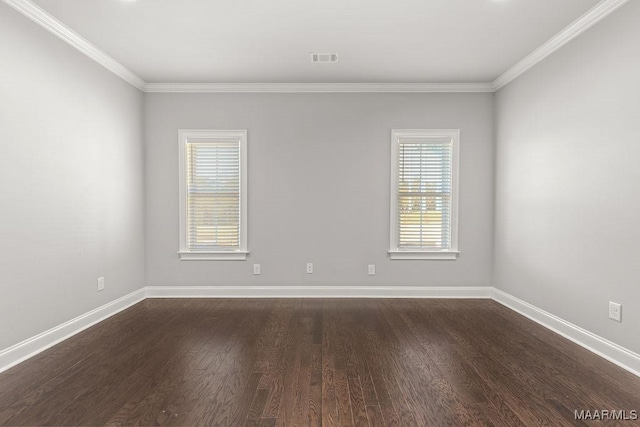 empty room featuring dark hardwood / wood-style flooring and ornamental molding