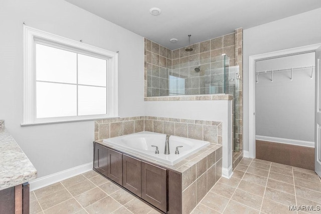 bathroom featuring tile patterned flooring and separate shower and tub