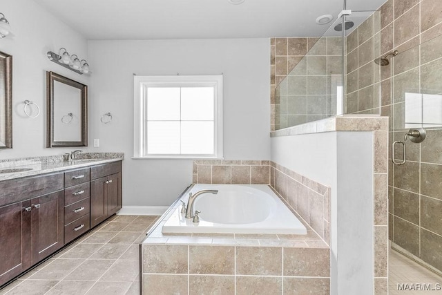 bathroom with tile patterned flooring, vanity, and separate shower and tub