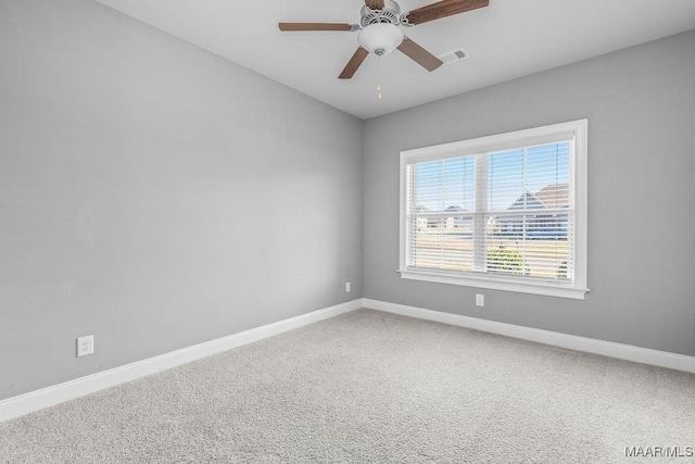 carpeted spare room featuring ceiling fan