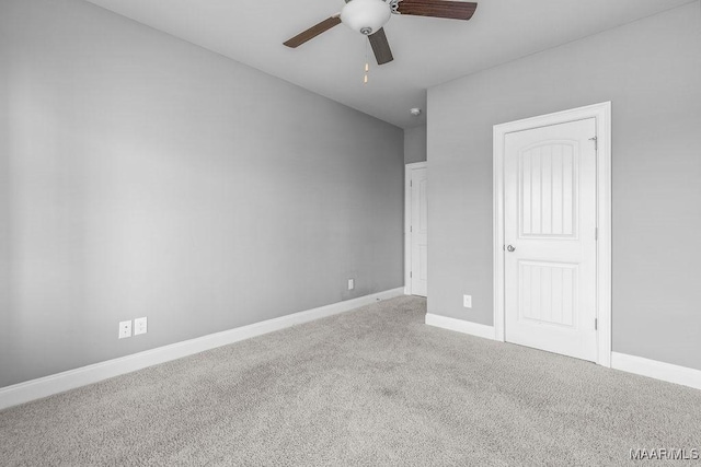 unfurnished bedroom featuring ceiling fan and carpet