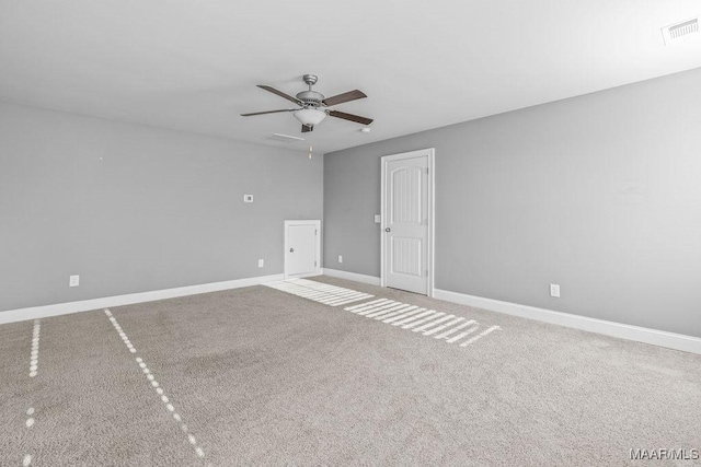 spare room with carpet floors and ceiling fan