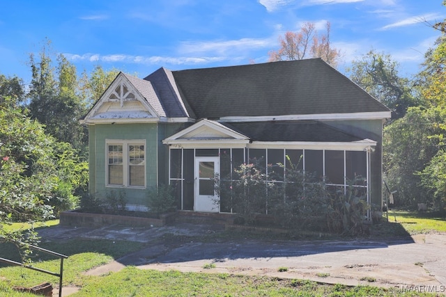 view of front of home with a sunroom