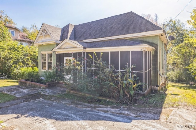 view of front facade with a sunroom