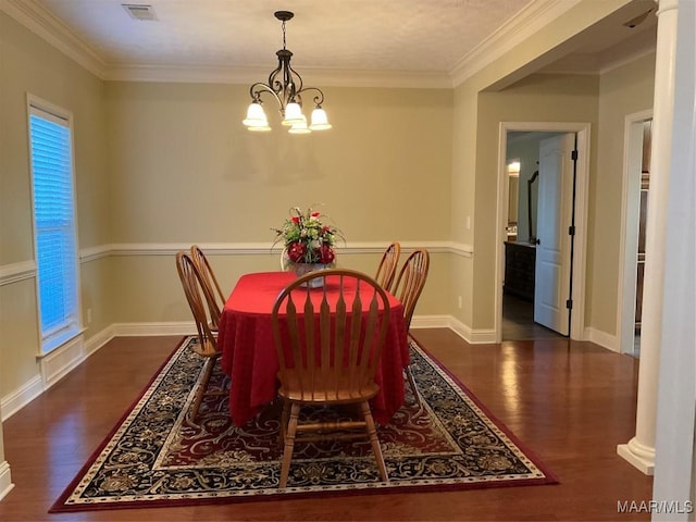 dining room featuring a notable chandelier, dark hardwood / wood-style flooring, and ornamental molding