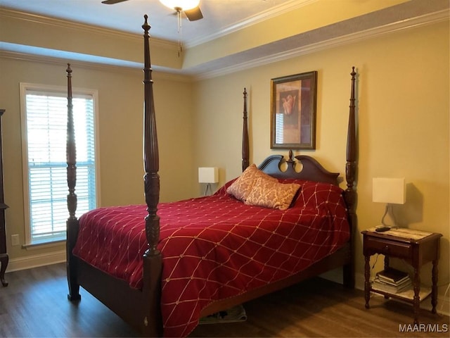 bedroom with hardwood / wood-style floors, a tray ceiling, ceiling fan, and crown molding