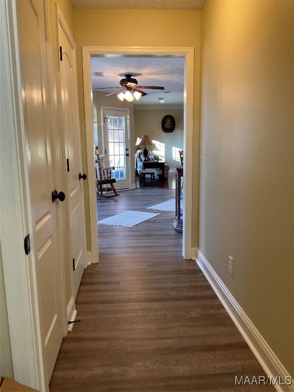 hallway with dark hardwood / wood-style floors