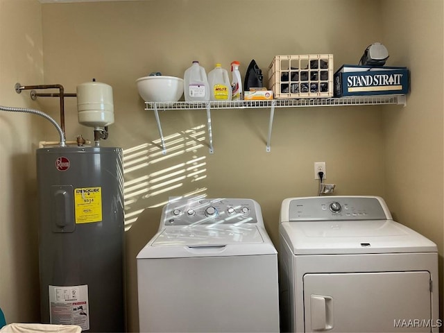 clothes washing area with electric water heater and separate washer and dryer