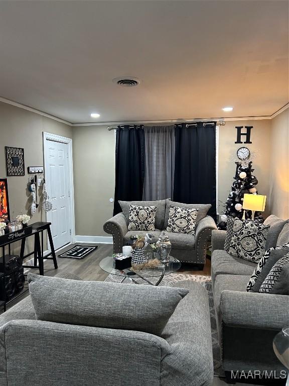 living room with hardwood / wood-style floors and ornamental molding