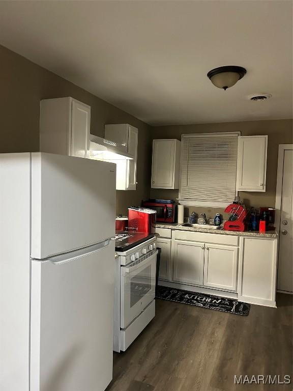 kitchen featuring white cabinetry, sink, dark wood-type flooring, and white appliances