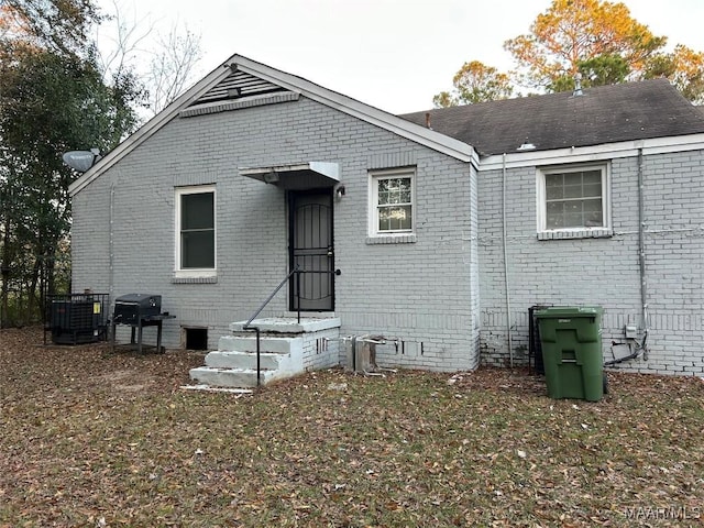 rear view of property featuring central AC