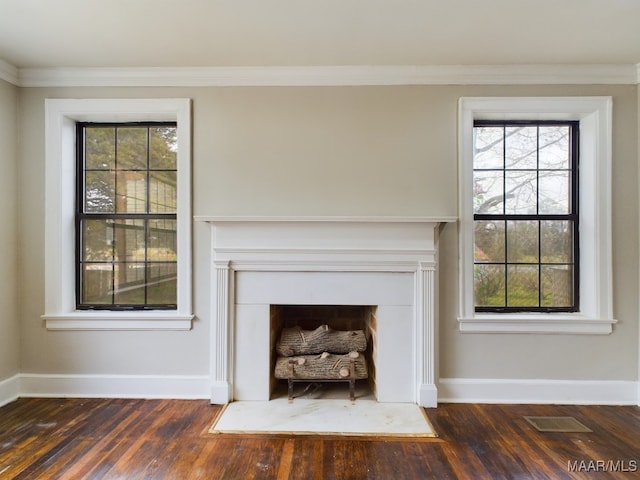 unfurnished living room with ornamental molding and dark wood-type flooring