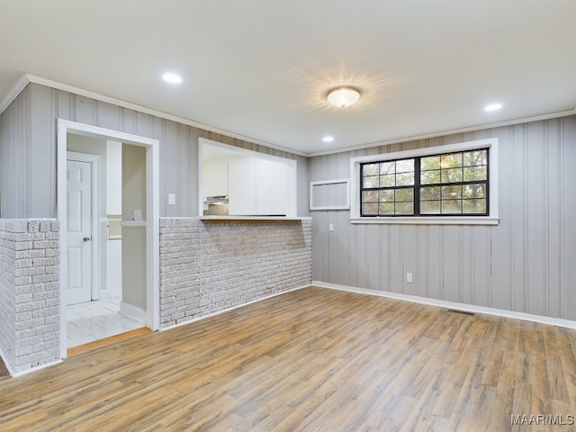 unfurnished room with light hardwood / wood-style flooring and ornamental molding