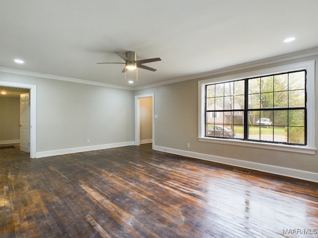 empty room featuring ceiling fan, dark hardwood / wood-style flooring, and crown molding