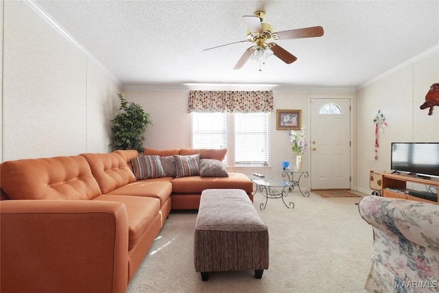 carpeted living room featuring a textured ceiling, ceiling fan, and ornamental molding