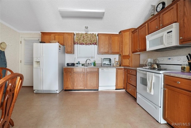 kitchen featuring a textured ceiling, white appliances, and sink