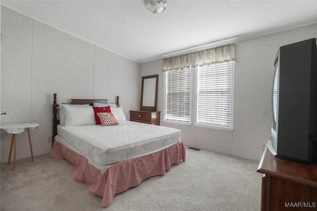 carpeted bedroom featuring a textured ceiling