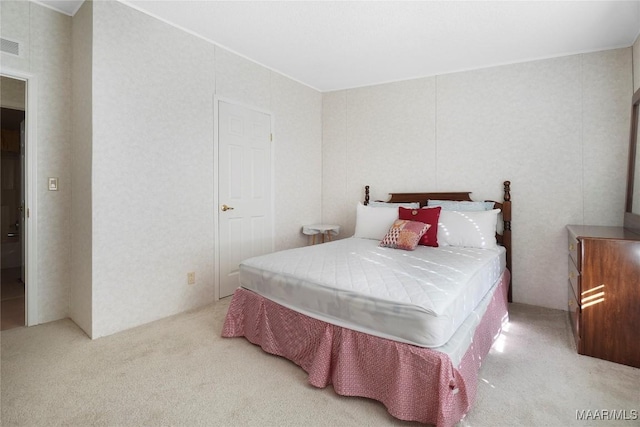 bedroom featuring light carpet