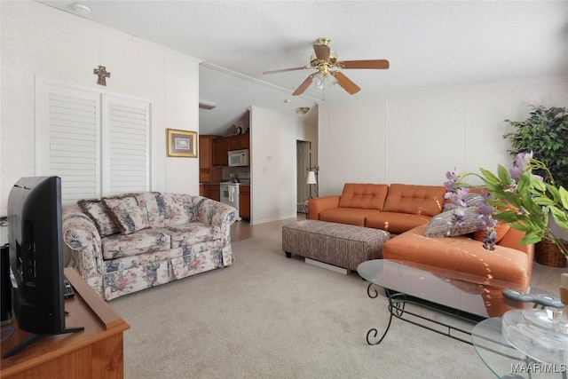 carpeted living room with ceiling fan, a textured ceiling, and ornamental molding