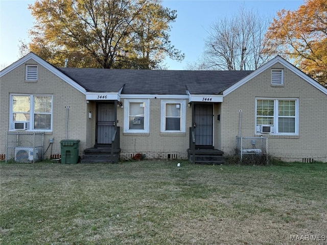 view of front of house featuring a front lawn and cooling unit