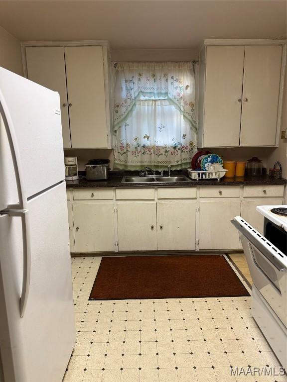 kitchen featuring white appliances and sink