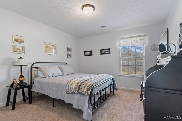 carpeted bedroom with a textured ceiling