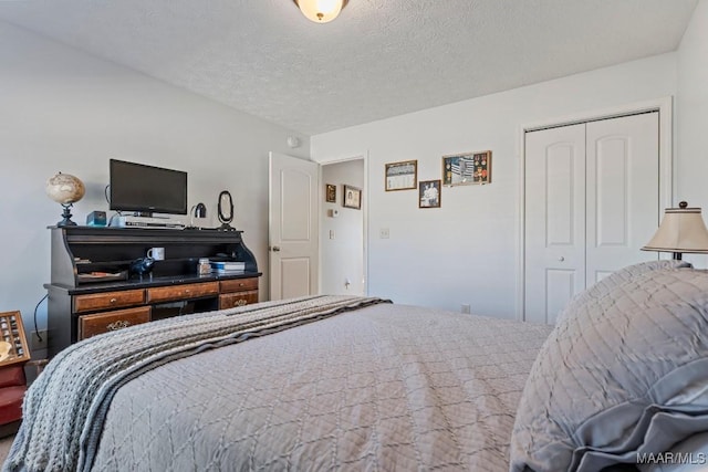 bedroom with a textured ceiling and a closet