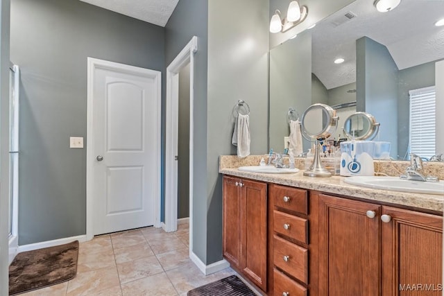 bathroom featuring tile patterned floors, vanity, and a textured ceiling