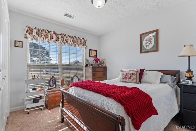 bedroom featuring carpet and a textured ceiling