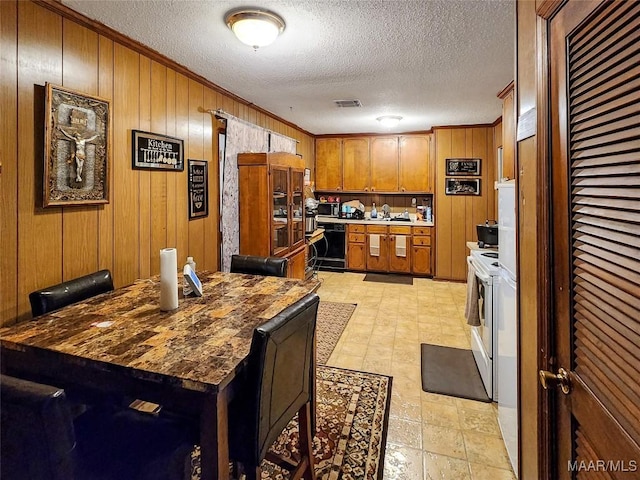 kitchen with ornamental molding, white electric range oven, a textured ceiling, wooden walls, and dishwasher