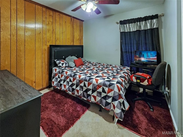 carpeted bedroom with ceiling fan and wooden walls