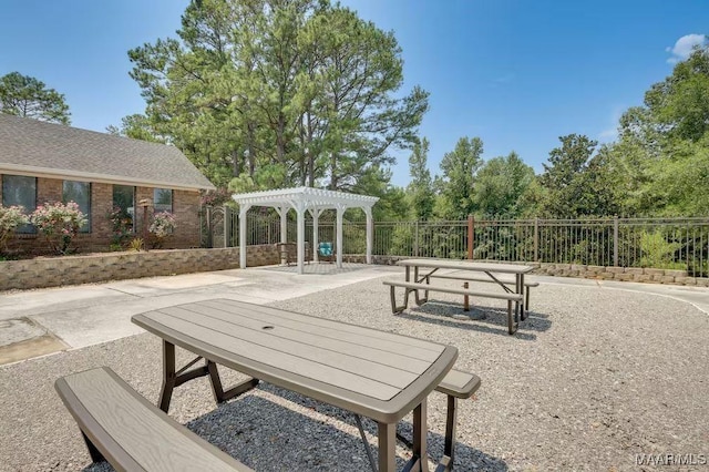 view of property's community with a patio area and a pergola