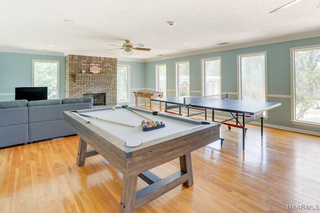 rec room with a textured ceiling, plenty of natural light, crown molding, and billiards