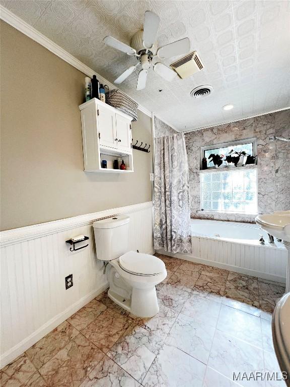 bathroom featuring ceiling fan, toilet, and ornamental molding