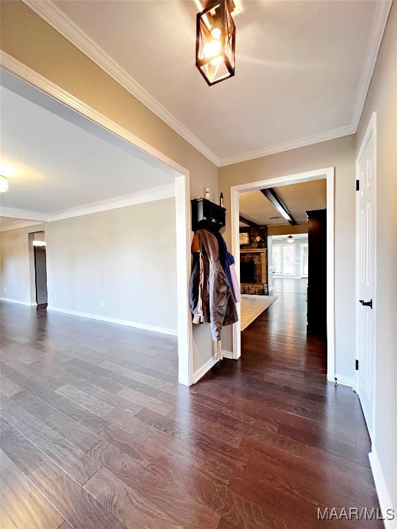 hallway with ornamental molding and dark wood-type flooring