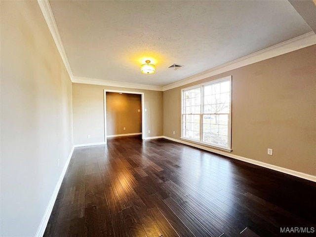 spare room featuring dark hardwood / wood-style floors and ornamental molding