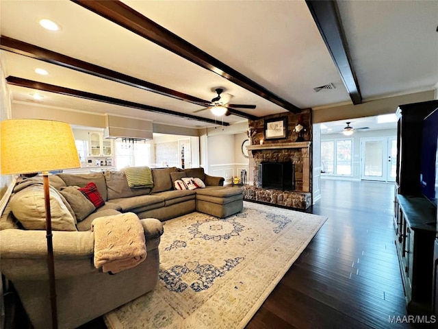 living room featuring a fireplace, plenty of natural light, beamed ceiling, and wood-type flooring