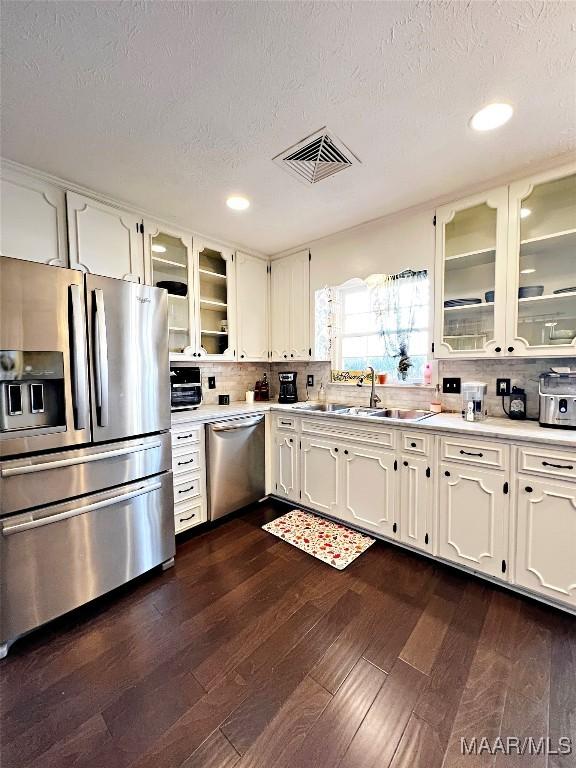 kitchen with white cabinetry, sink, and stainless steel appliances