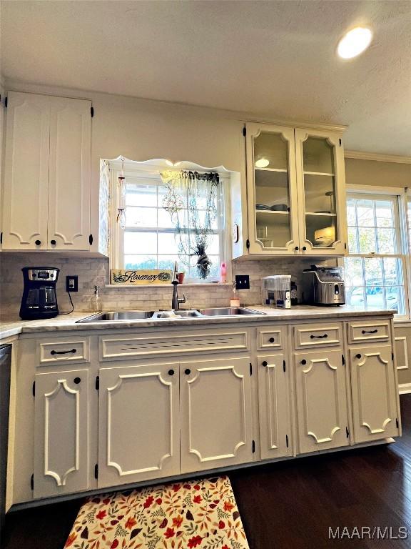 kitchen featuring tasteful backsplash, dark hardwood / wood-style flooring, white cabinetry, and sink