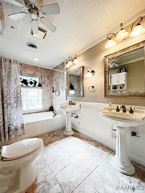 bathroom featuring a tub, crown molding, and toilet