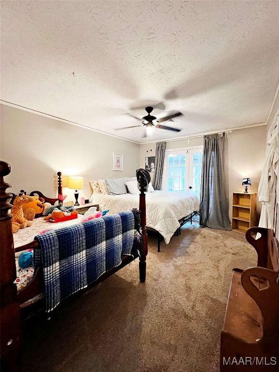 carpeted bedroom with a textured ceiling and ceiling fan