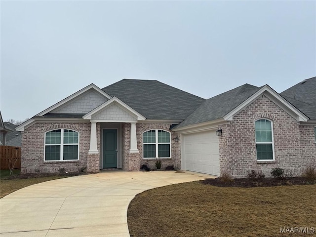 view of front of house featuring a front yard and a garage