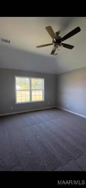 carpeted empty room featuring a wealth of natural light and ceiling fan