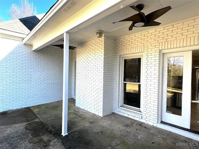 entrance to property featuring a patio area and ceiling fan