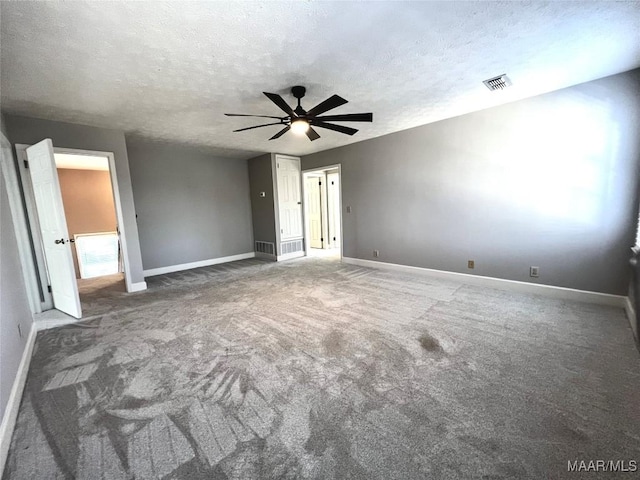 empty room with ceiling fan, carpet floors, and a textured ceiling