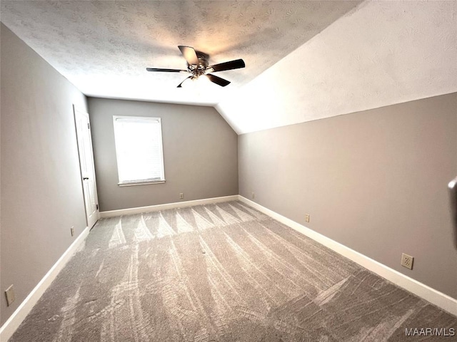 bonus room with ceiling fan, lofted ceiling, a textured ceiling, and carpet floors