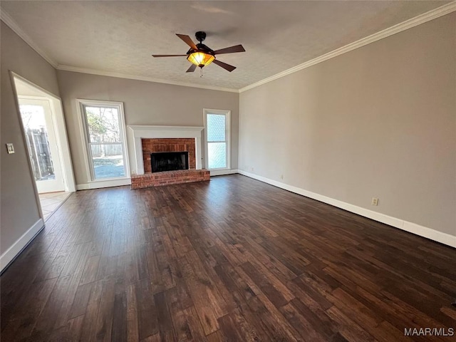 unfurnished living room with a fireplace, dark hardwood / wood-style floors, ceiling fan, and crown molding